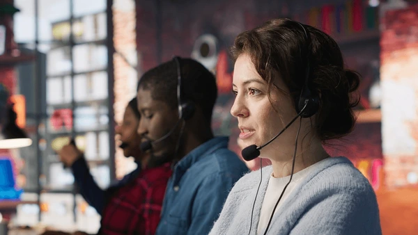 Call center agent wearing a headset on a live transfer call
